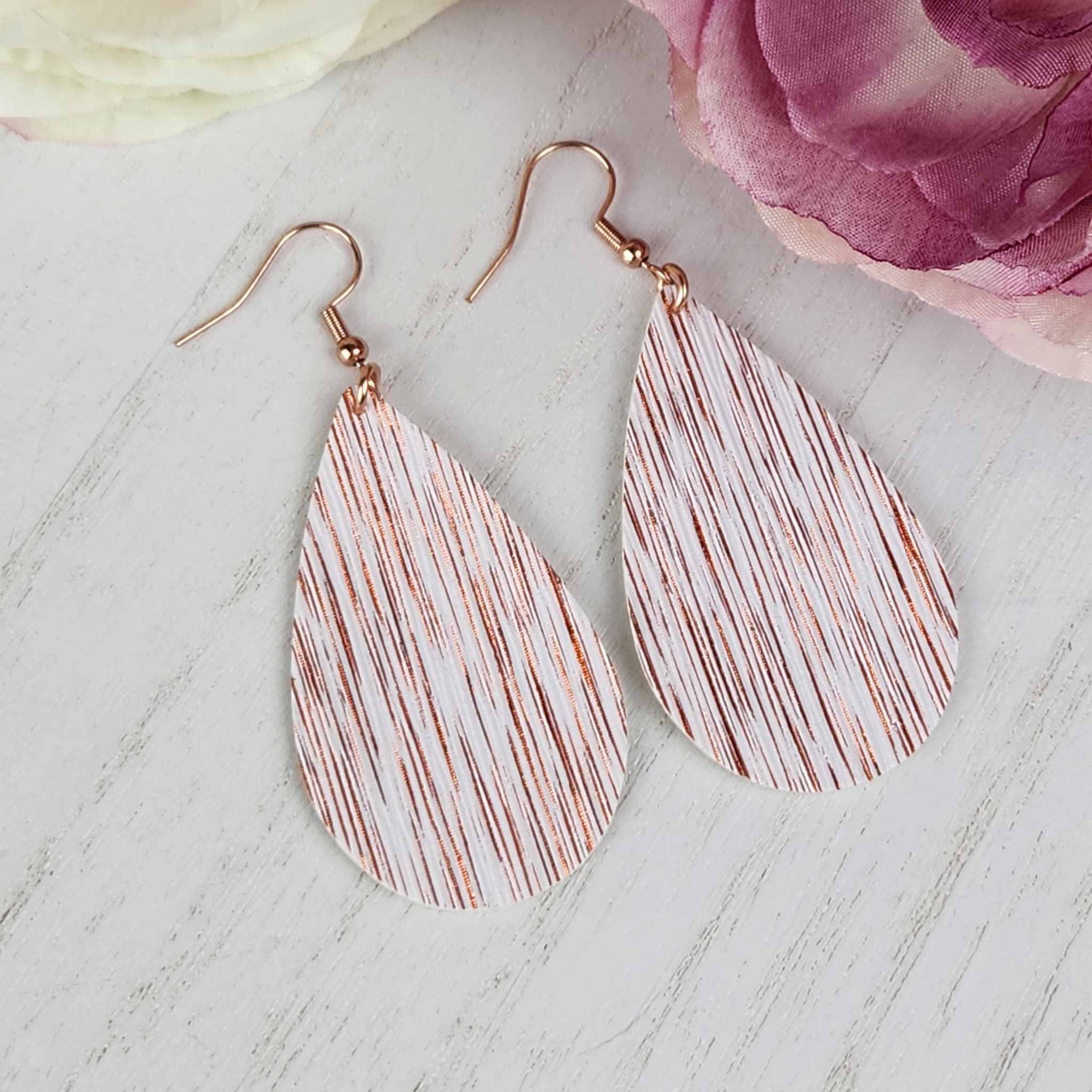 White teardrop danlges with copper streaks made with hypoallergenic hooks.