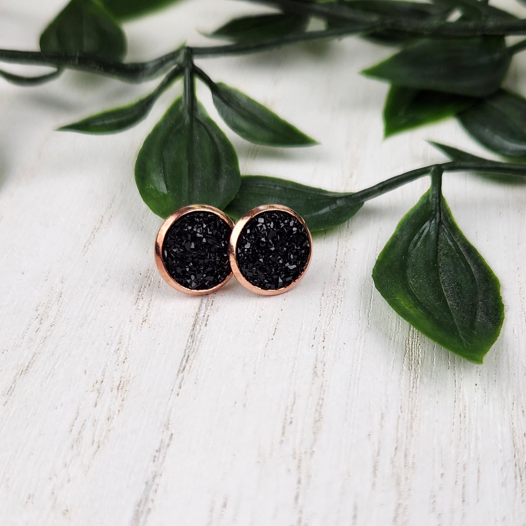 Beautiful black crystal cluster studs. Studs are made with hypoallergenic gold plated findings, and are 10mm in diameter.