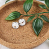 Hypoallergenic silver plated studs with faux leather inlay. Inlay is an elegant white pattern with silver speckles. Studs are 10mm in diameter.