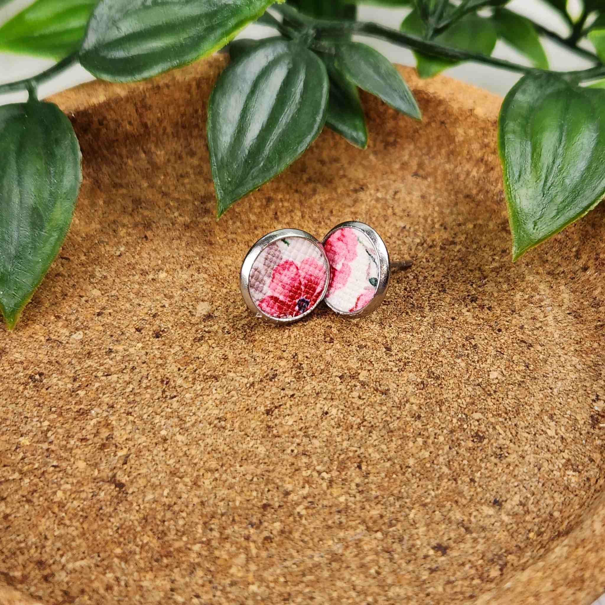 These cute studs have a pink floral faux leather inlay. They are made with hypoallergenic gold plated studs and are 10mm in diameter.