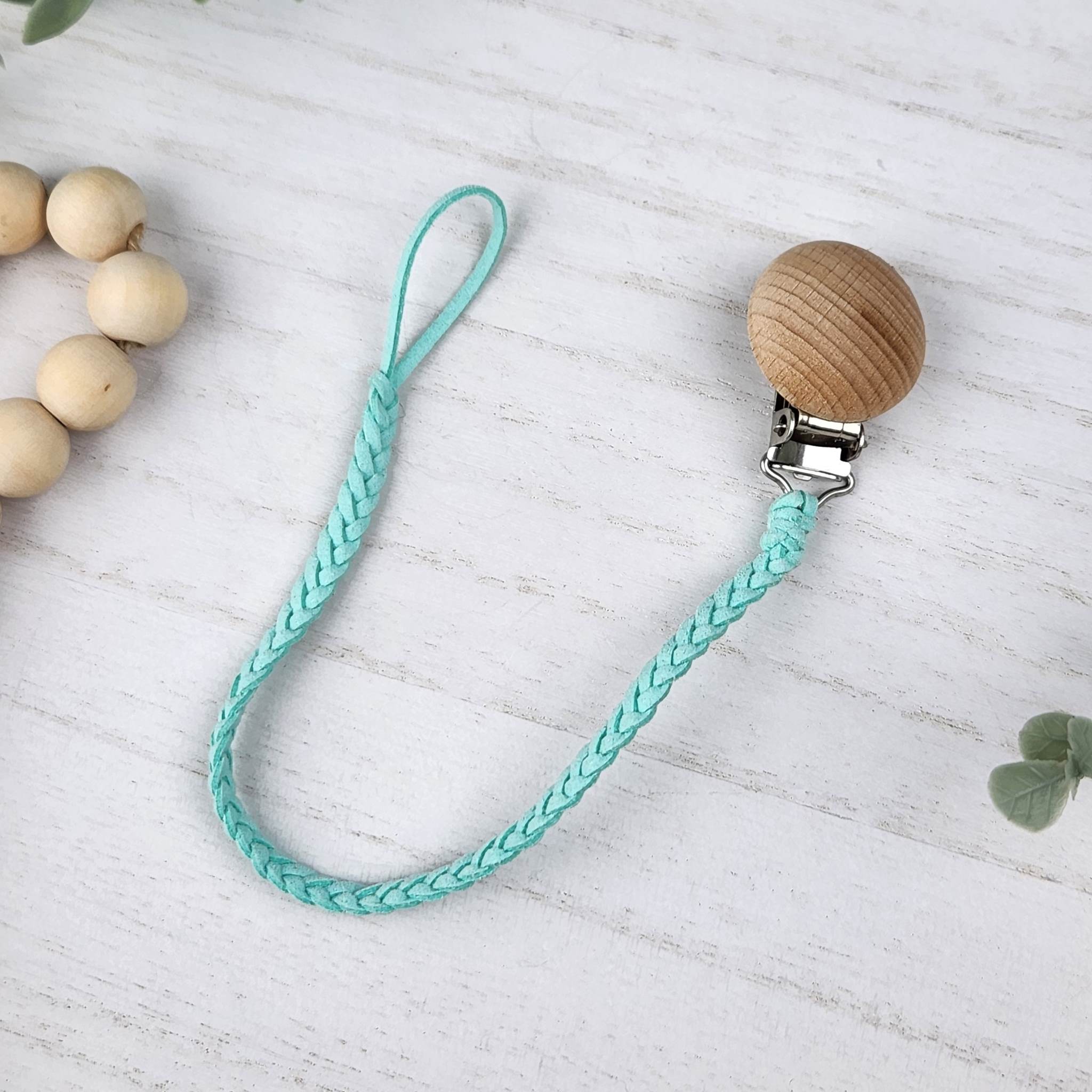 Aqua Blue soother clip with leather braided cord and a wooden clip