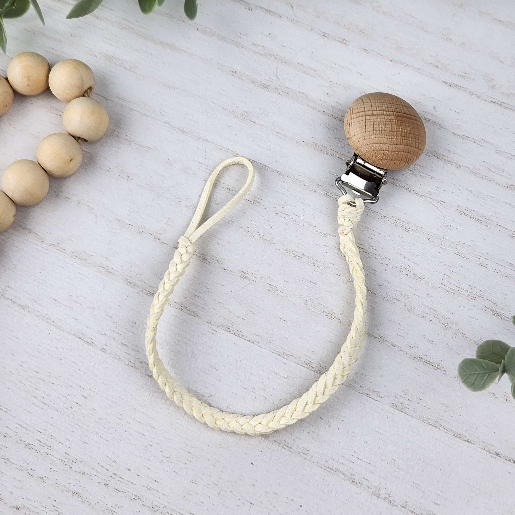 Chiffon Creme soother clip with leather braided cord and a wooden clip