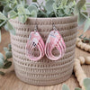 Curled pink cotton earrings made with hypoallergenic hooks.