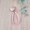 Light Pink soother clip with leather braided cord and a wooden clip