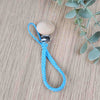 Light Blue soother clip with leather braided cord and a wooden clip