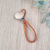 Rustic Orange soother clip with leather braided cord and a wooden clip