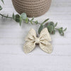 Creme white sailor bow made with faux leather, has an alligator clip to fasten to hair.