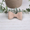 A classic bow made with beige faux leather. Has an alligator clip to fasten to hair.