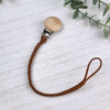 Dark Cinnamon soother clip with leather braided cord and a wooden clip