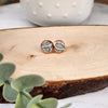 These studs are made with a grey faux leather inlay and hypoallergenic rose gold findings. They are 10mm in diameter.