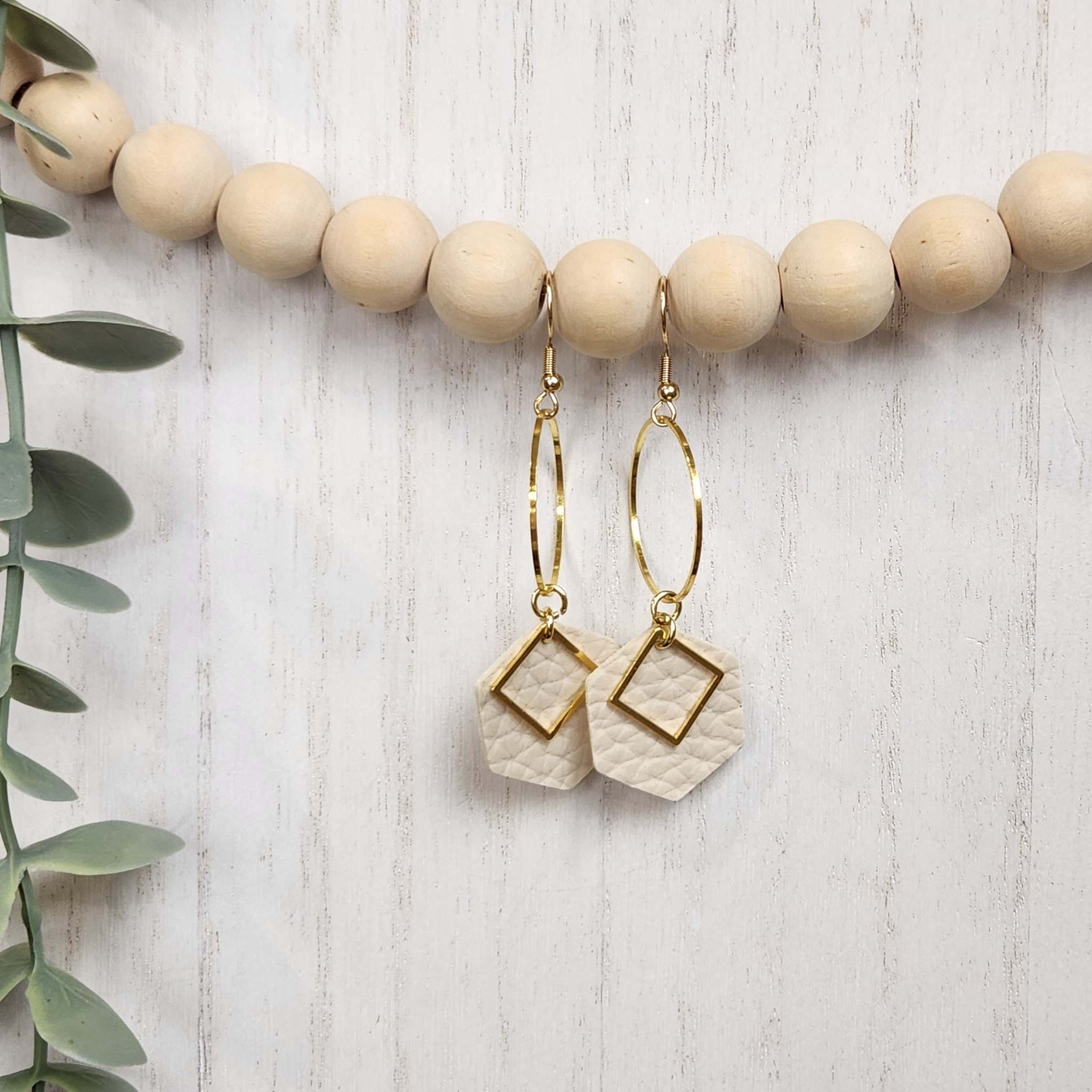 Cream colored elegant hexagon dangle earrings. Made with hypoallergenic hooks.