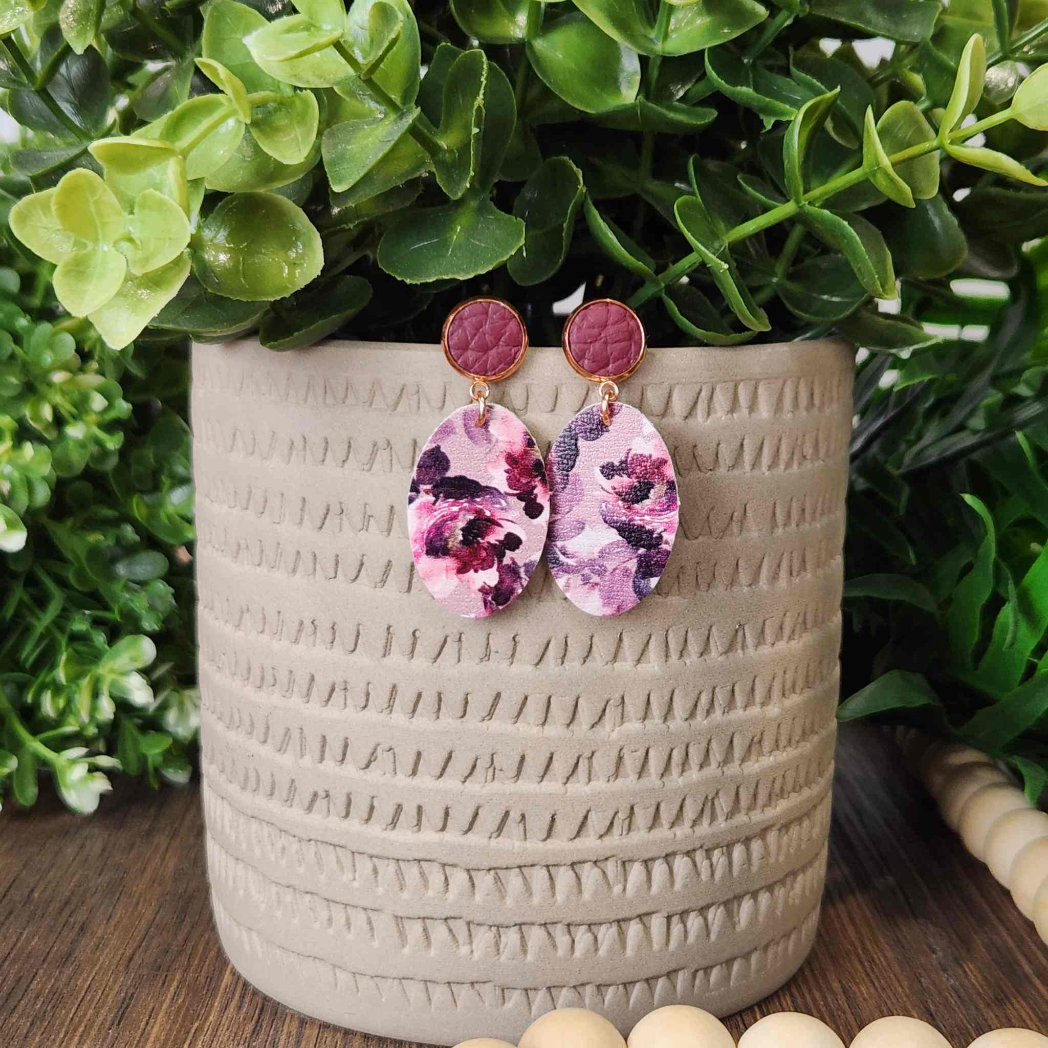 Deep red and purple studs with floral oval dangle. Made with hypoallergenic hooks.