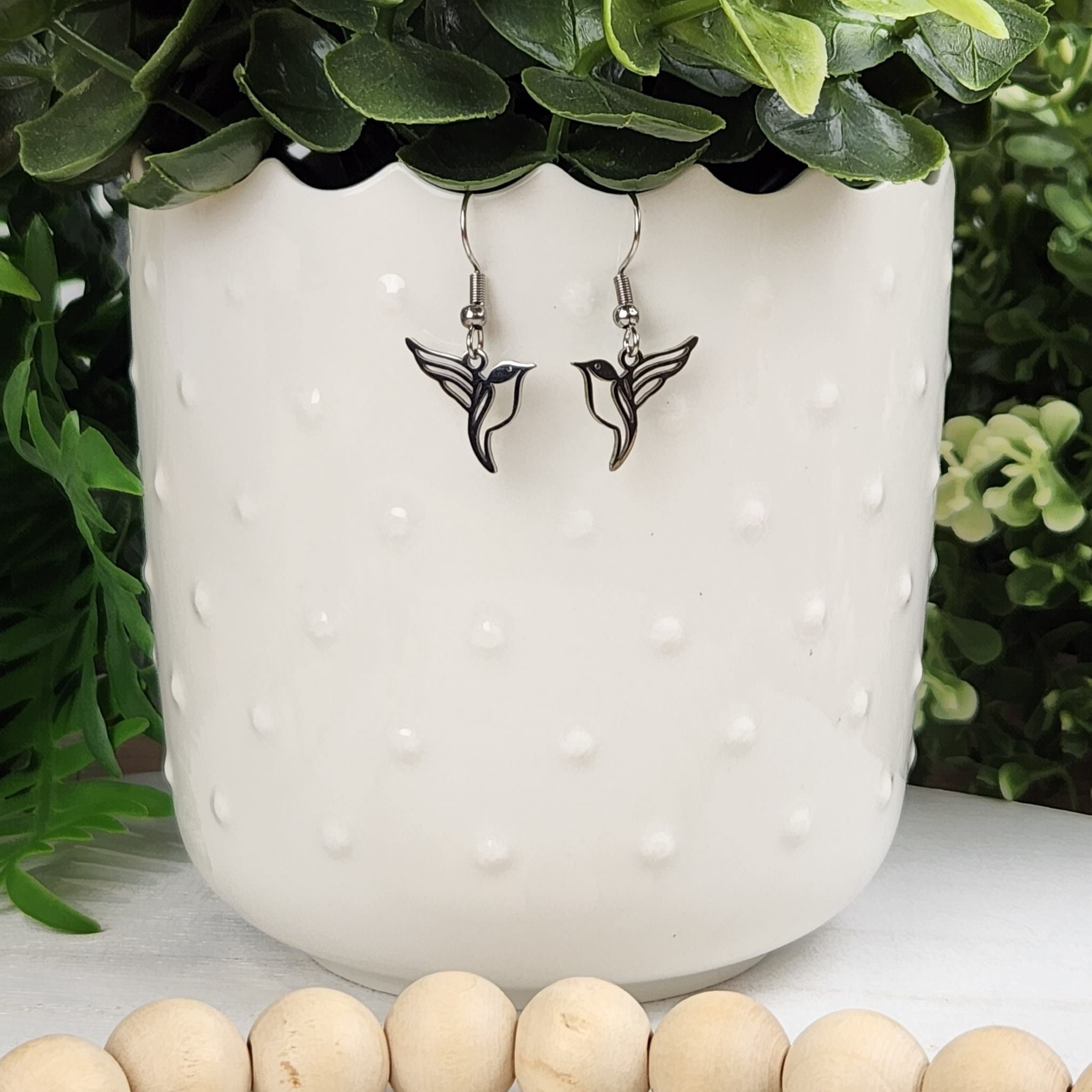 Dainty silver hummingbird earrings.  Made with hypoallergenic hooks.