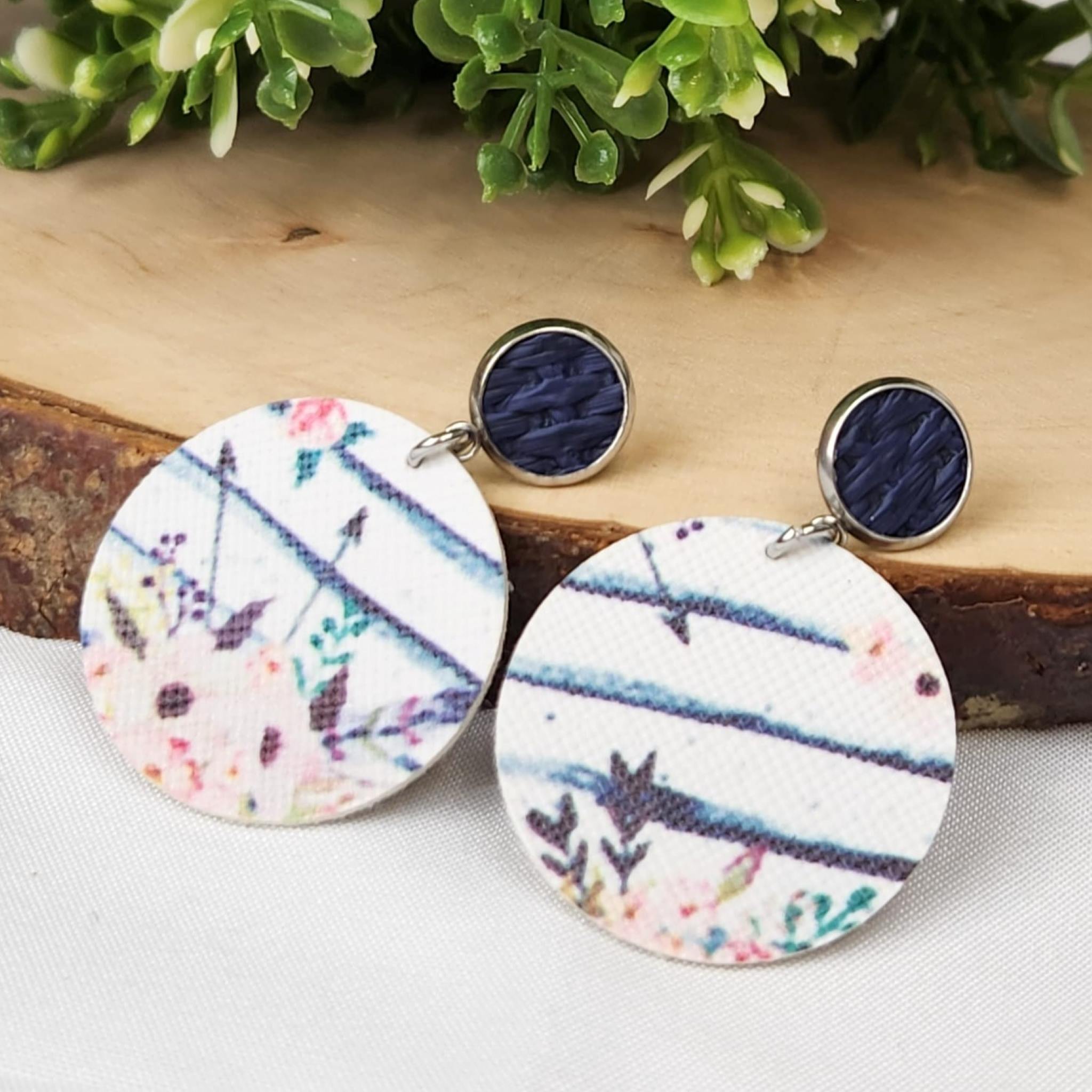 Blue studs with faux leather whitewash floral dangle. Hypoallergenic findings were used.