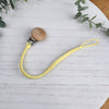 Sunshine Yellow soother clip with leather braided cord and a wooden clip